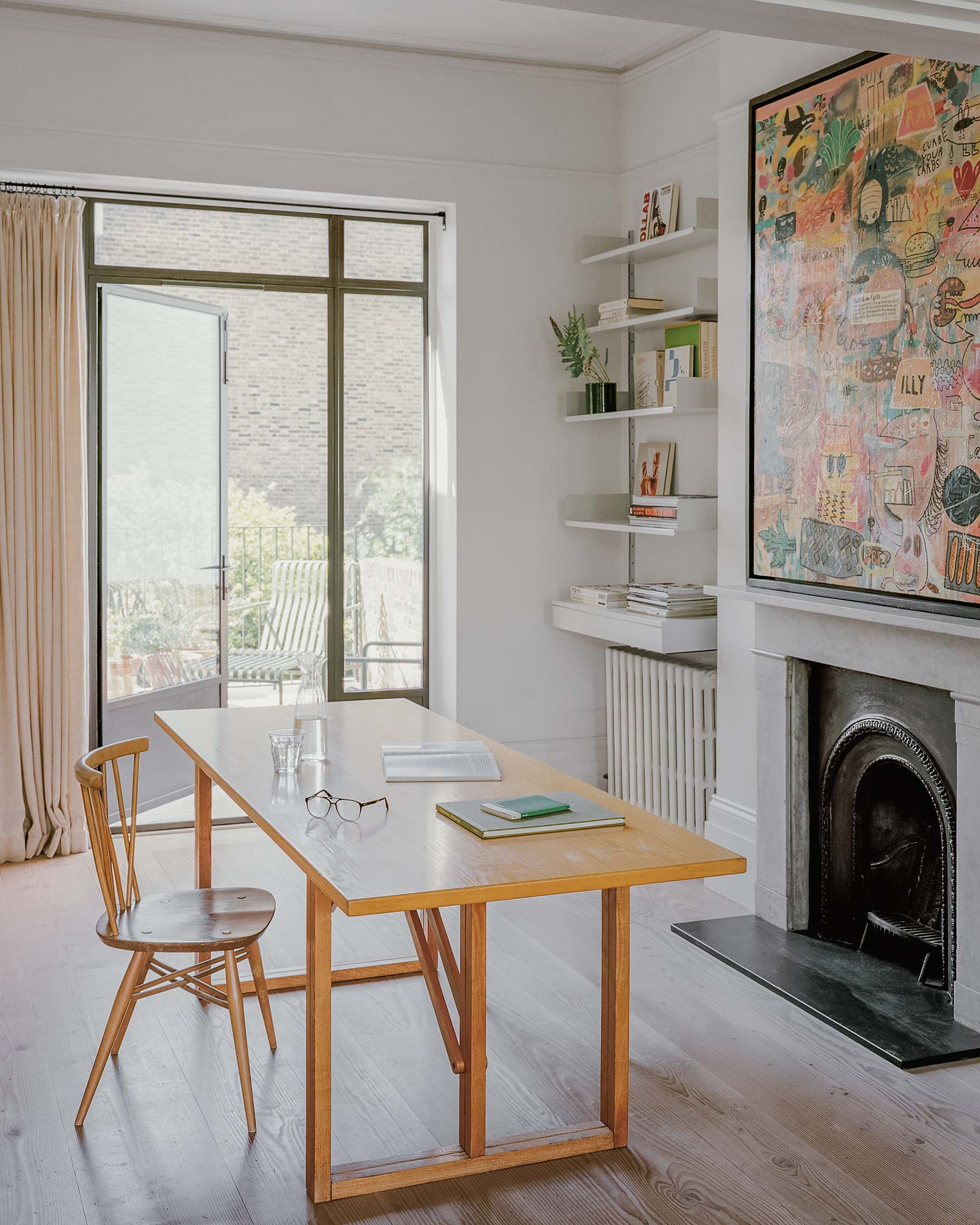 study victorian house art studio with paintings, fireplace and desk