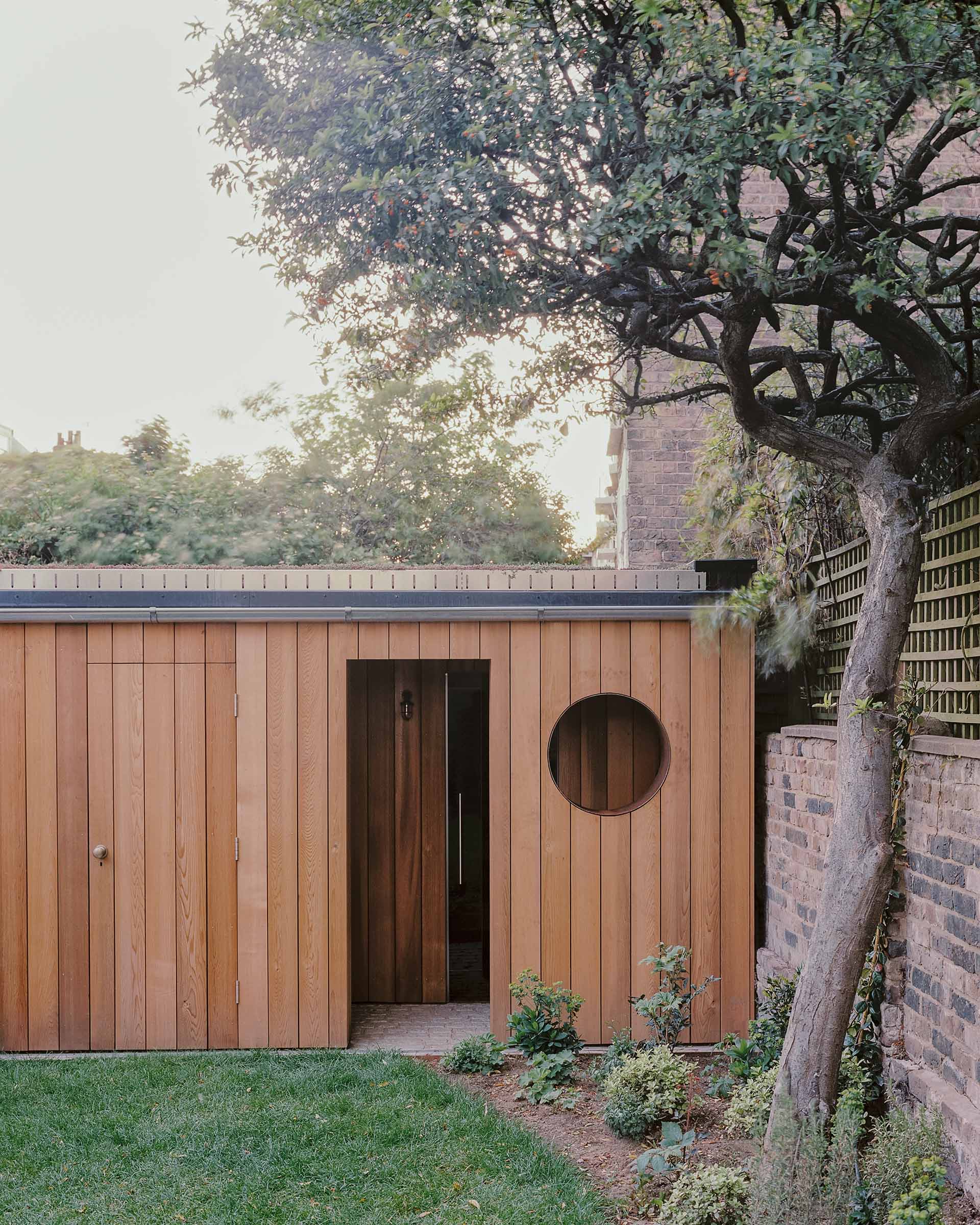 timber cladding to garden room with sauna and outdoor shower in london