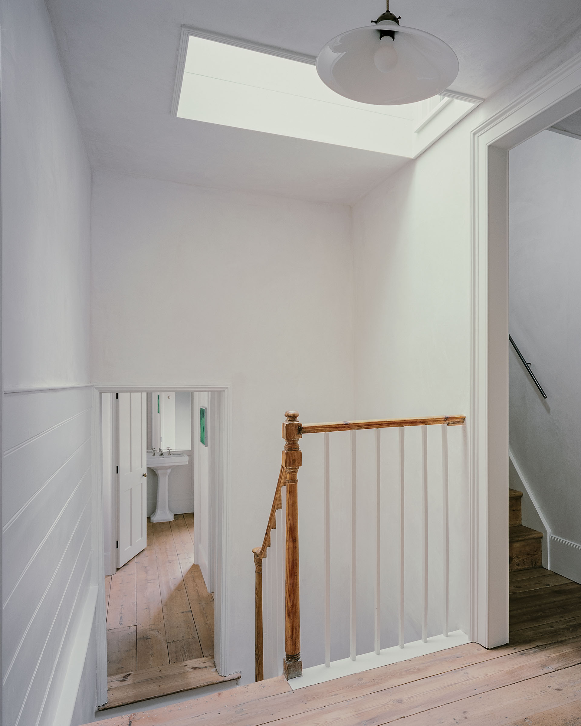 Georgian house: original staircase with timber newel post and curved balustrade, skylight and lime plaster