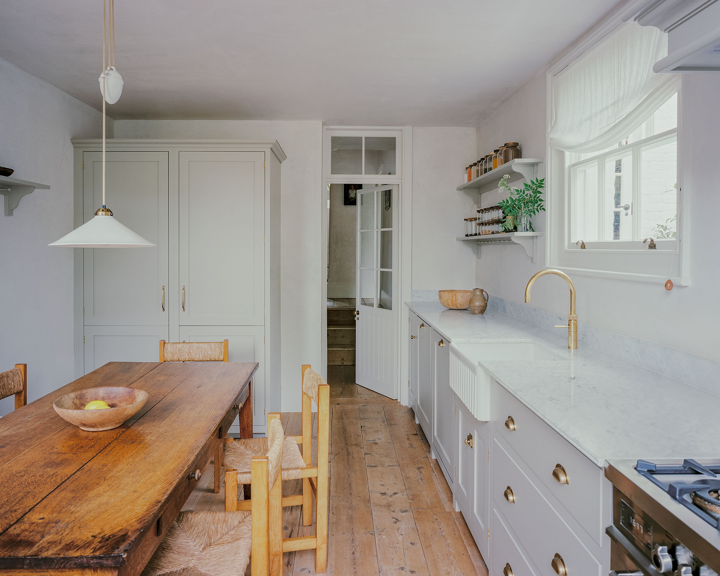 Hampstead house with a traditional shaker panelled kitchen, sash window and Georgian pine floorboards